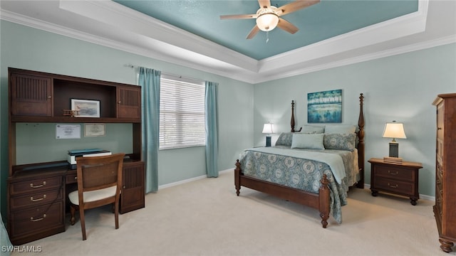 bedroom with ceiling fan, crown molding, light carpet, and a tray ceiling