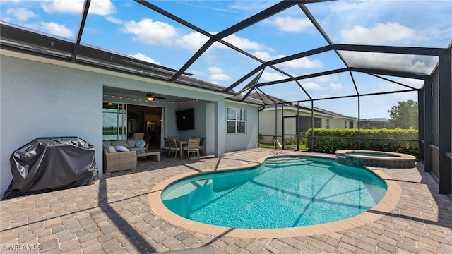 view of swimming pool with ceiling fan, a patio, a lanai, and area for grilling