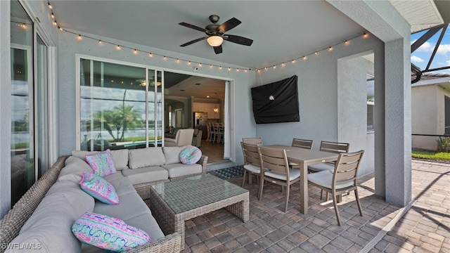 view of patio with ceiling fan and an outdoor living space