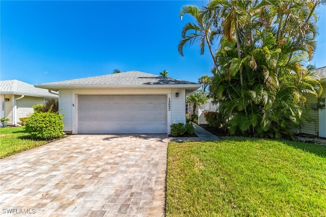 view of front facade with a front yard and a garage