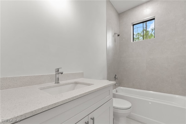 full bathroom featuring toilet, tiled shower / bath combo, and vanity