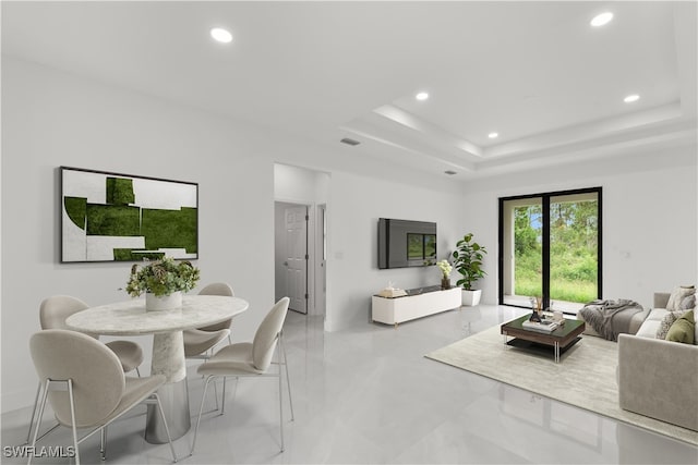 living room featuring a raised ceiling