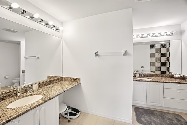 bathroom with vanity, toilet, and tile patterned floors