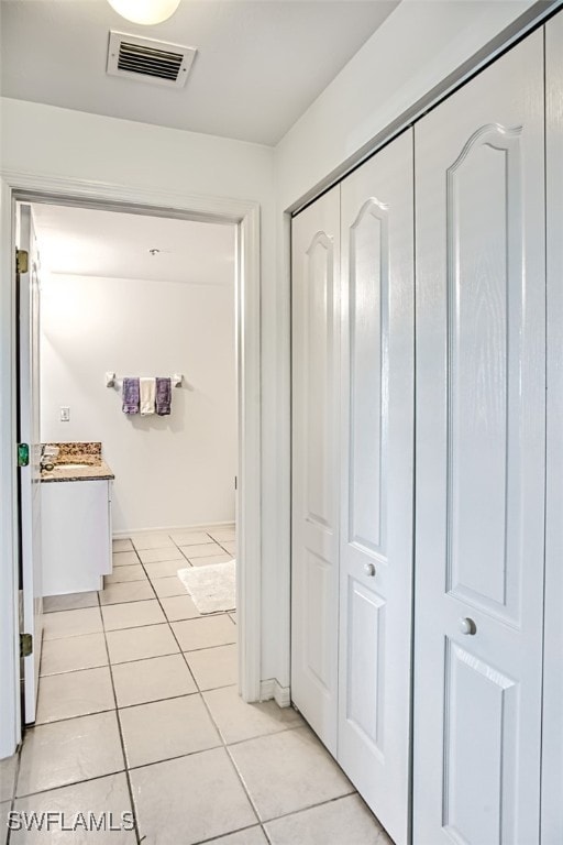 corridor featuring light tile patterned floors