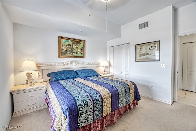 carpeted bedroom featuring a closet and ceiling fan