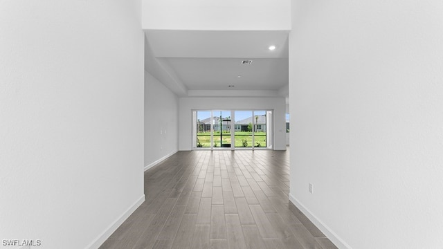 corridor with wood-type flooring