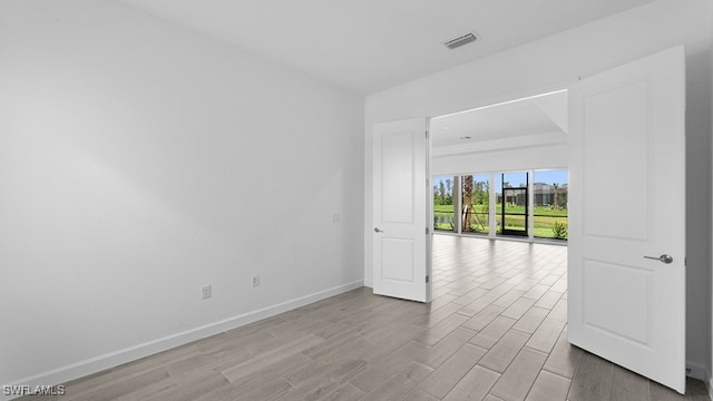 spare room featuring light hardwood / wood-style flooring