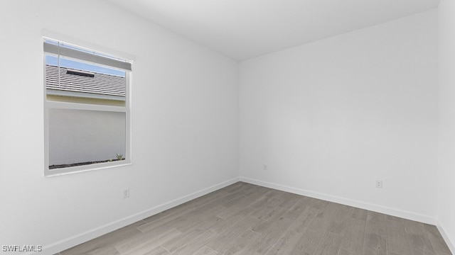 spare room featuring wood-type flooring