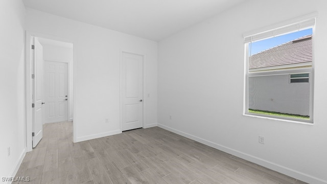 empty room featuring light hardwood / wood-style floors and a healthy amount of sunlight