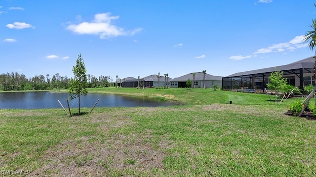 view of yard with glass enclosure and a water view