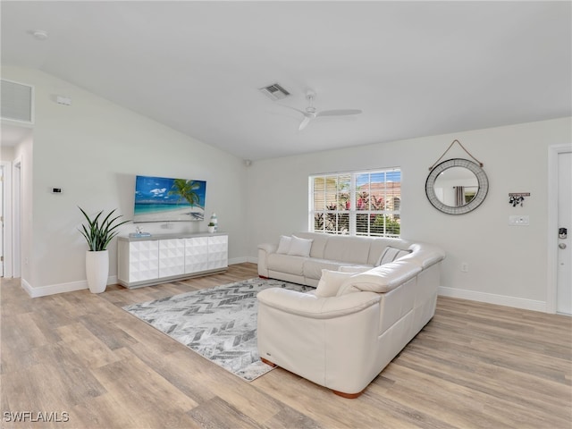 living room featuring lofted ceiling, light hardwood / wood-style floors, and ceiling fan