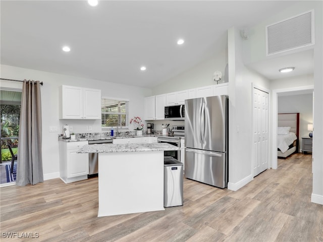 kitchen with light wood-type flooring, a center island, stainless steel appliances, and white cabinetry