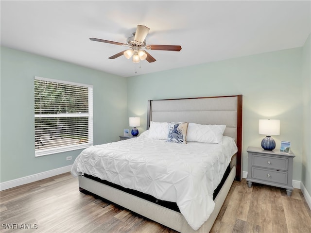 bedroom with light hardwood / wood-style flooring and ceiling fan