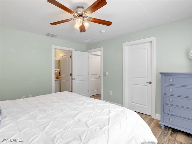 bedroom featuring light hardwood / wood-style floors, ensuite bath, and ceiling fan