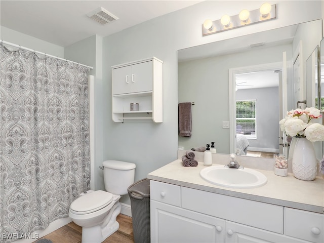 bathroom with vanity, hardwood / wood-style floors, and toilet