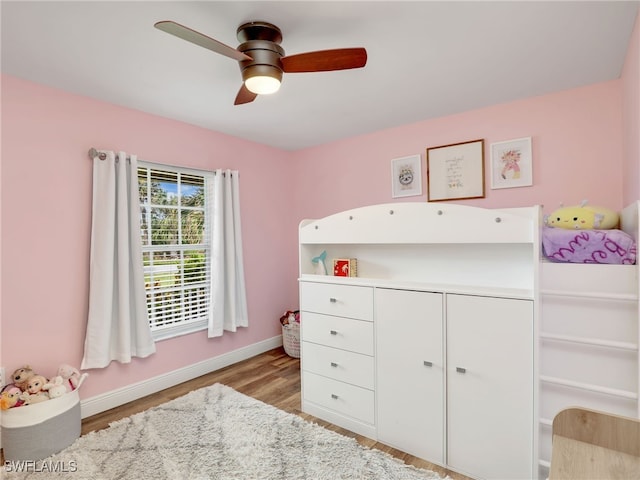 bedroom featuring a closet, light wood-type flooring, and ceiling fan