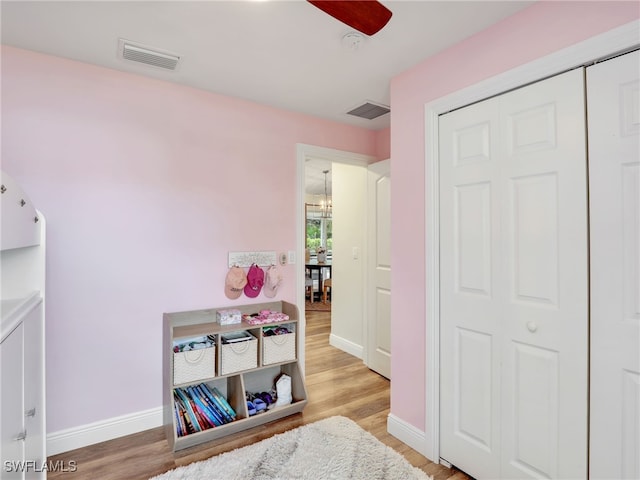 bedroom featuring light hardwood / wood-style floors, a closet, and ceiling fan