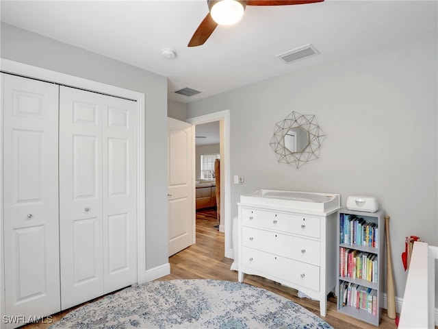 bedroom featuring light hardwood / wood-style floors, a closet, and ceiling fan