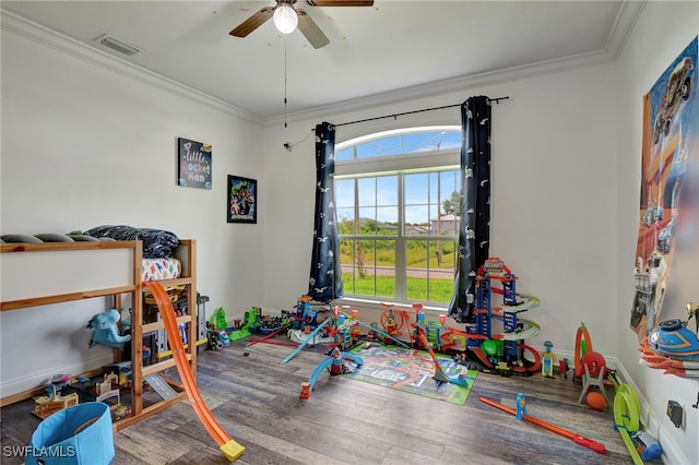 game room featuring ceiling fan, crown molding, and wood-type flooring