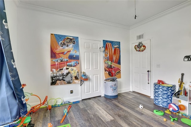 game room featuring dark hardwood / wood-style floors and ornamental molding