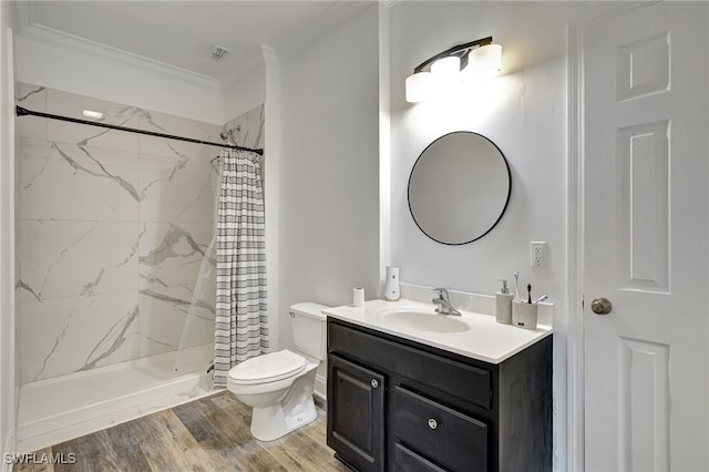 bathroom with toilet, a shower with curtain, vanity, ornamental molding, and wood-type flooring