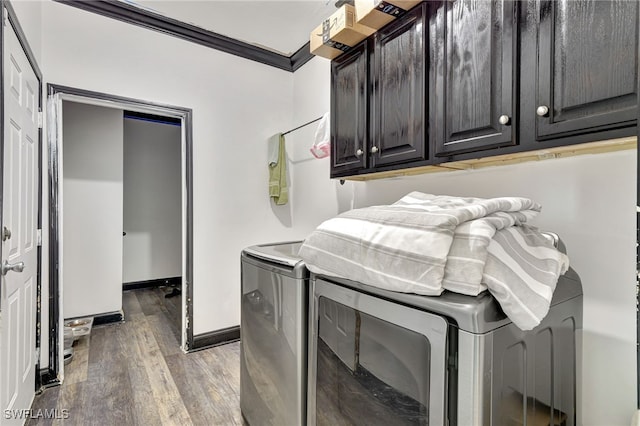 washroom with washer and clothes dryer, crown molding, cabinets, and light hardwood / wood-style floors