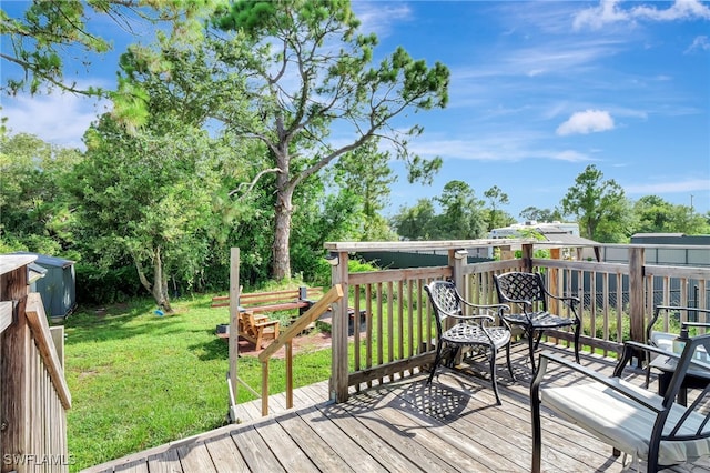 wooden terrace featuring a lawn