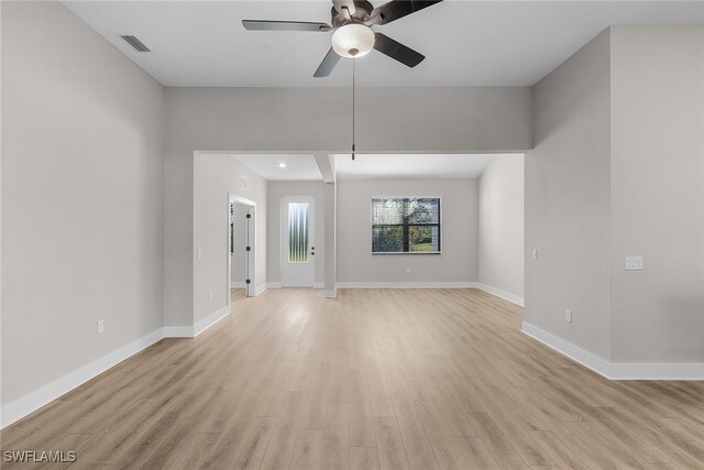 710 SW 21st St, Cape Coral, FL 33991 - unfurnished living room featuring a ceiling fan, light wood finished floors, and baseboards