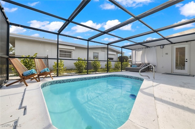 view of swimming pool with a patio area and glass enclosure