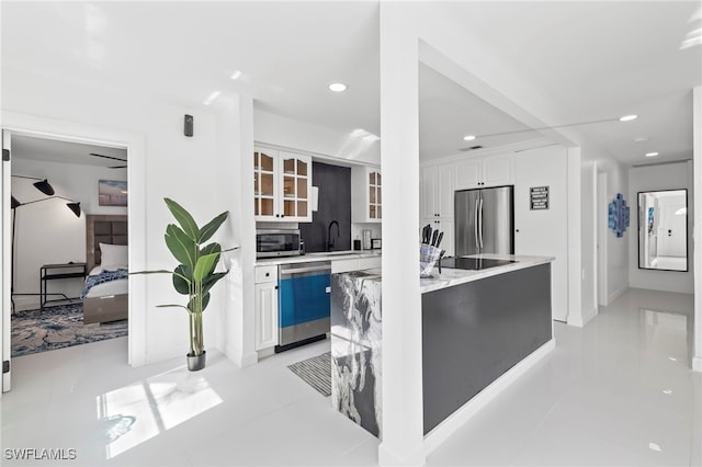 kitchen featuring white cabinetry, appliances with stainless steel finishes, and light tile patterned floors