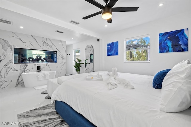 bedroom featuring ceiling fan, tile walls, and tile patterned flooring