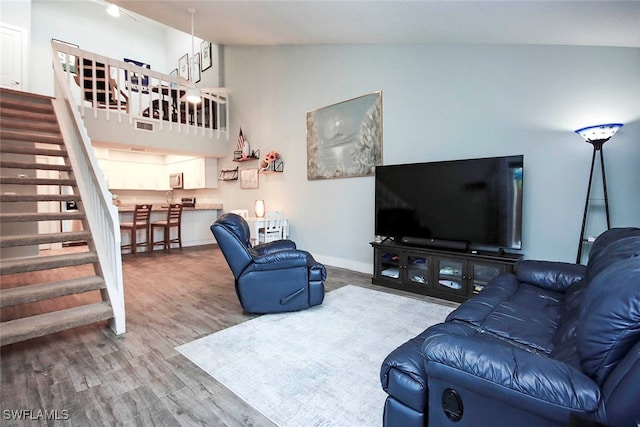 living room with wood-type flooring and vaulted ceiling