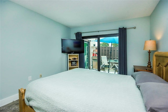 bedroom featuring hardwood / wood-style floors and access to exterior