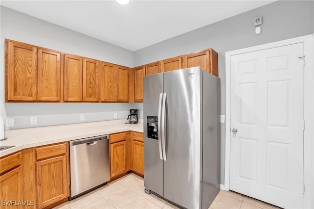 kitchen featuring appliances with stainless steel finishes and light tile patterned floors