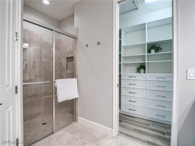 bathroom featuring a shower with shower door and hardwood / wood-style flooring