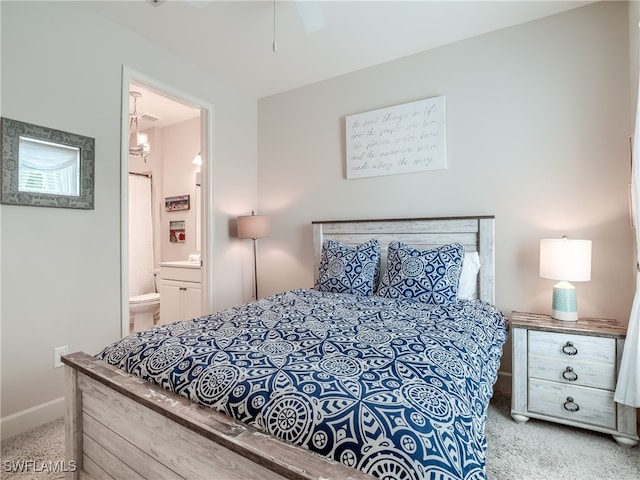 carpeted bedroom with ceiling fan and connected bathroom