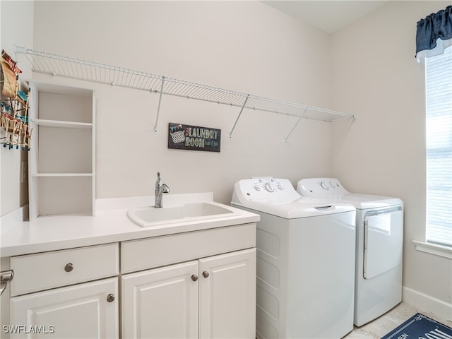 laundry area featuring plenty of natural light, independent washer and dryer, sink, and cabinets