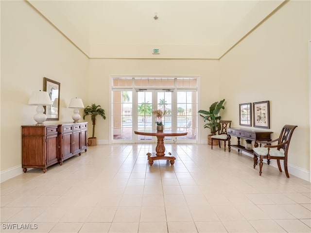 sitting room featuring light tile patterned floors and french doors