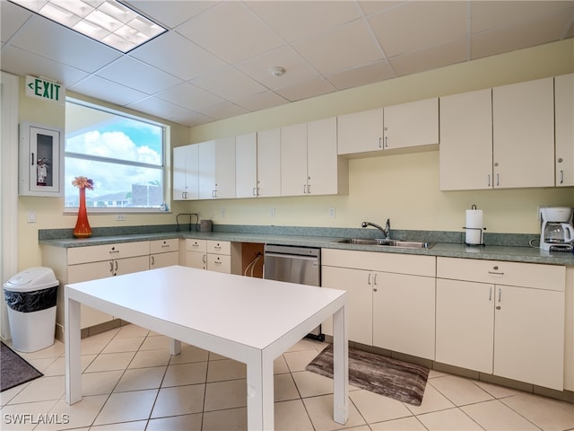 kitchen with dishwasher, sink, white cabinetry, and light tile patterned flooring