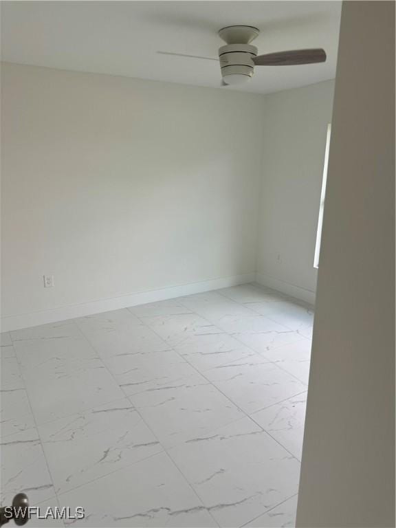 unfurnished room with light tile patterned floors and ceiling fan