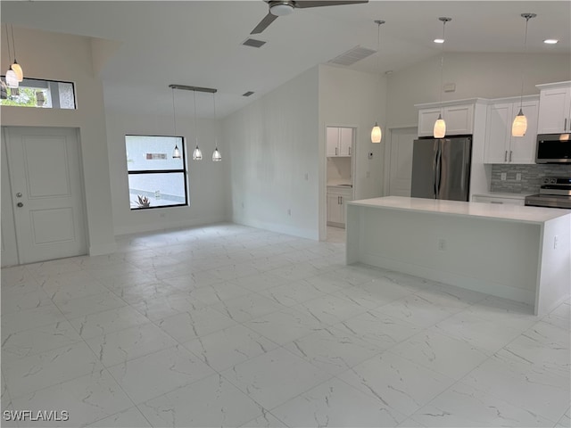 kitchen featuring light tile patterned flooring, a healthy amount of sunlight, and stainless steel appliances