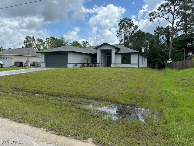 view of front of home with a garage and a front lawn