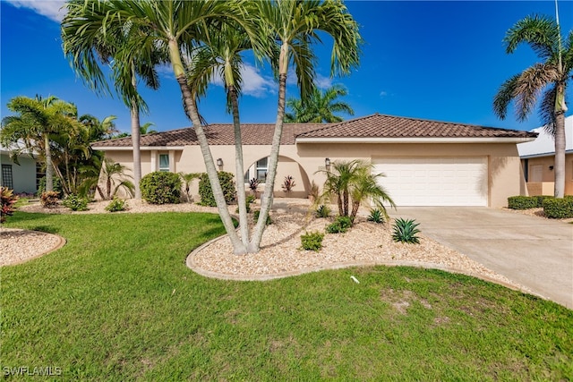 mediterranean / spanish-style home with a garage and a front yard