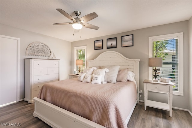 bedroom with ceiling fan and dark hardwood / wood-style floors