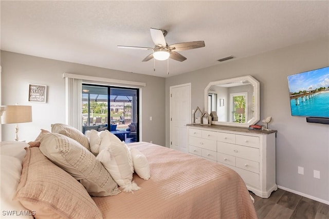 bedroom featuring dark hardwood / wood-style flooring, access to outside, and ceiling fan