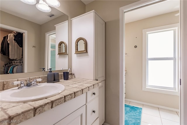 bathroom with tile patterned flooring and vanity