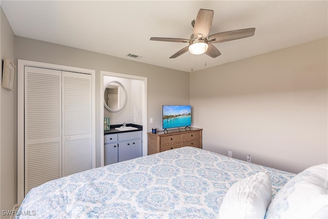 bedroom featuring ceiling fan, sink, a closet, and connected bathroom