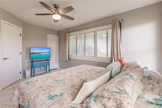 tiled bedroom featuring ceiling fan