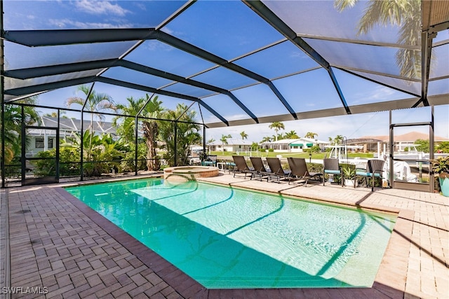 view of swimming pool featuring a patio and glass enclosure