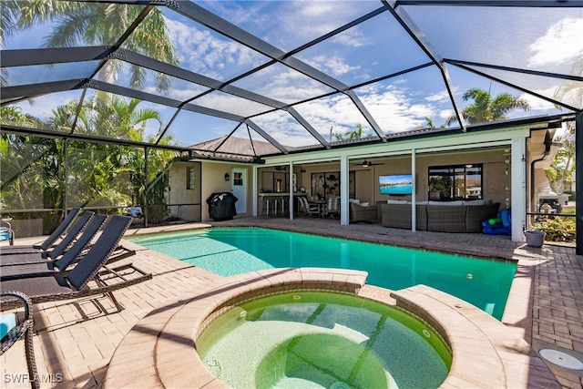 view of swimming pool with a patio area, an in ground hot tub, an outdoor hangout area, and a lanai